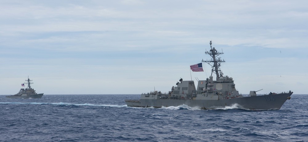 SOUTH CHINA SEA (FEB. 09, 2021) USS Sterett (DDG 104) and USS John S. McCain (DDG 56) steam alongside USS Nimitz (CVN 68). The USS Nimitz and USS Theodore Roosevelt Carrier Strike Groups are conducting dual carrier operations in the Indo-Pacific in support of maritime security operations and theater security cooperation efforts. U.S. Navy photo by Mass Communication Specialist Seaman Caitlin Flynn